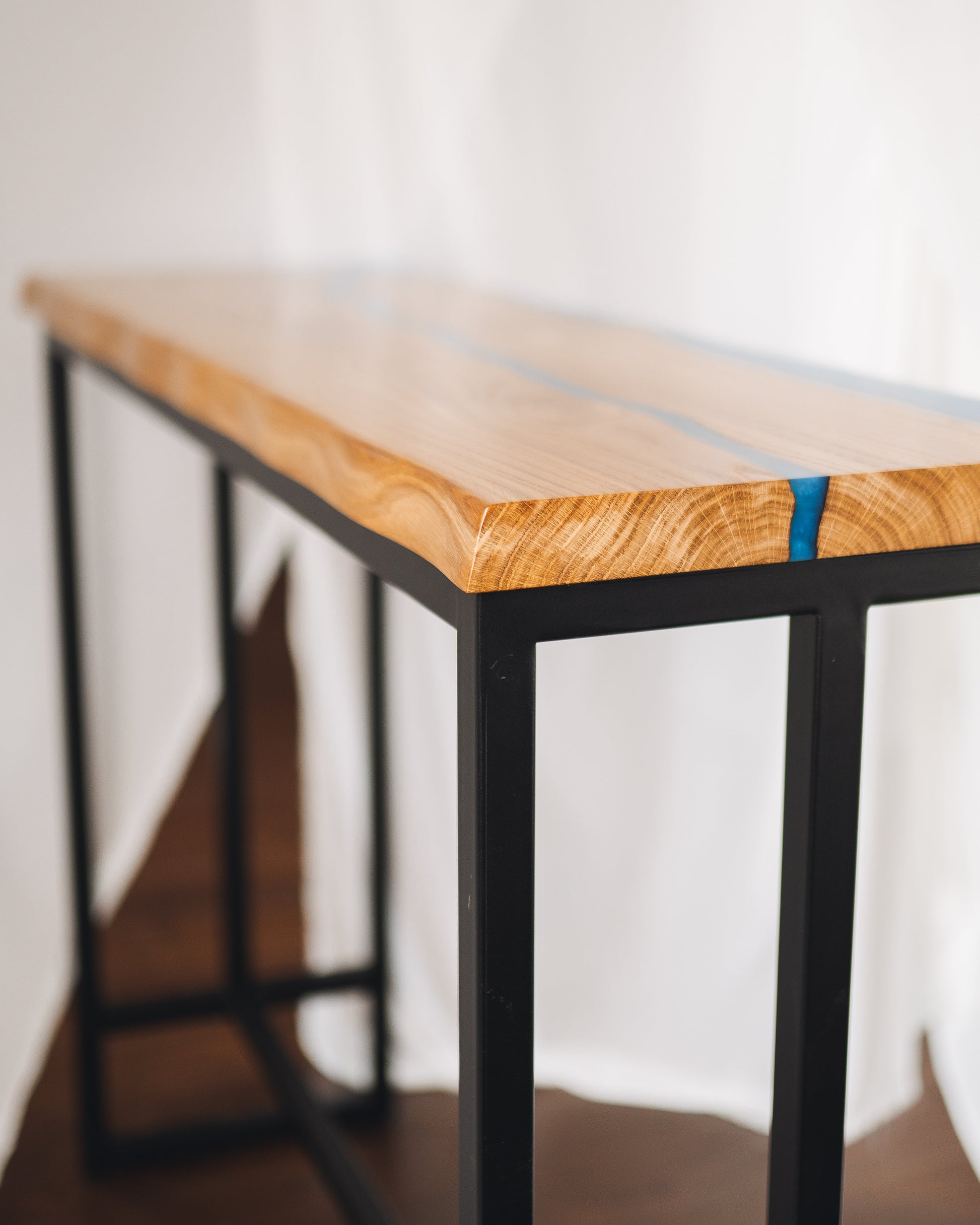 Bar table in live edge oak with blue epoxy river, front angle