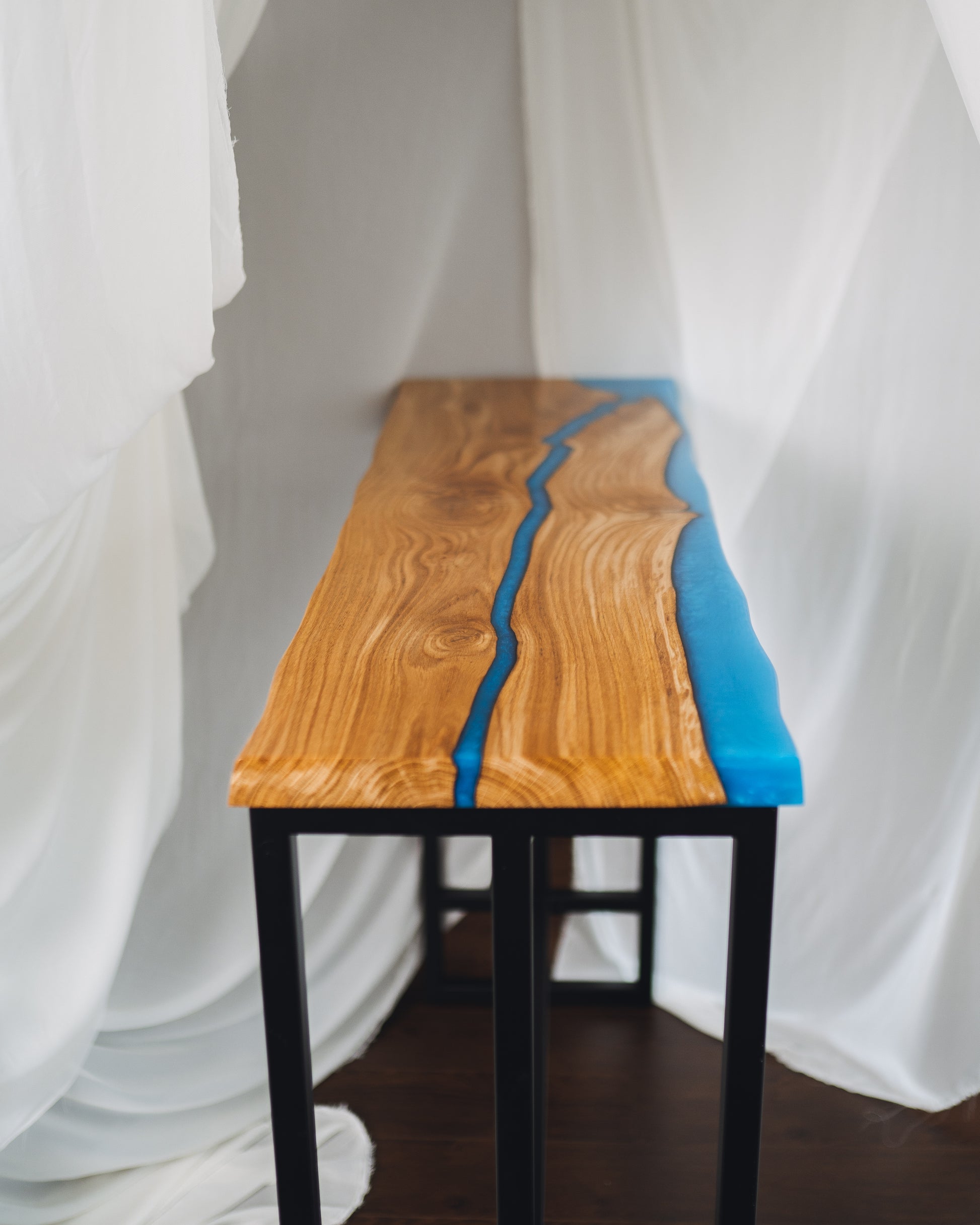 Bar table top-down view of blue epoxy river pattern
