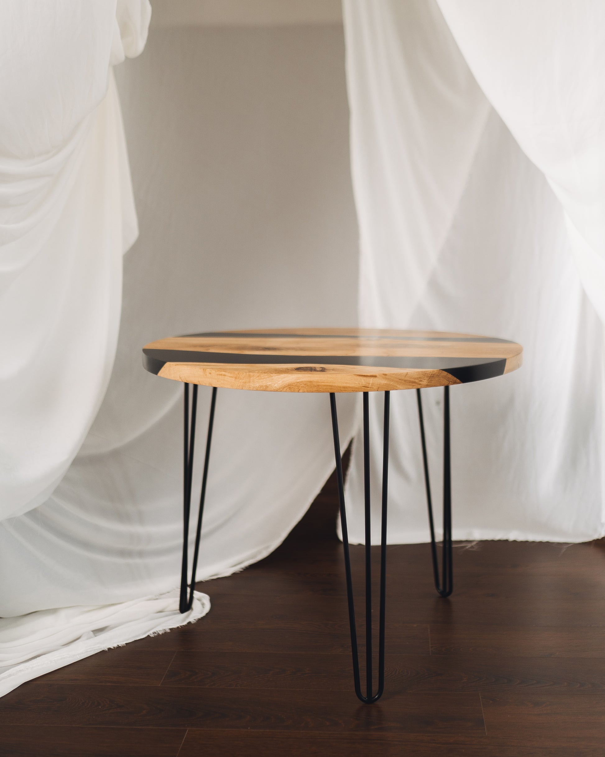 Side angle of oak coffee table with hairpin legs