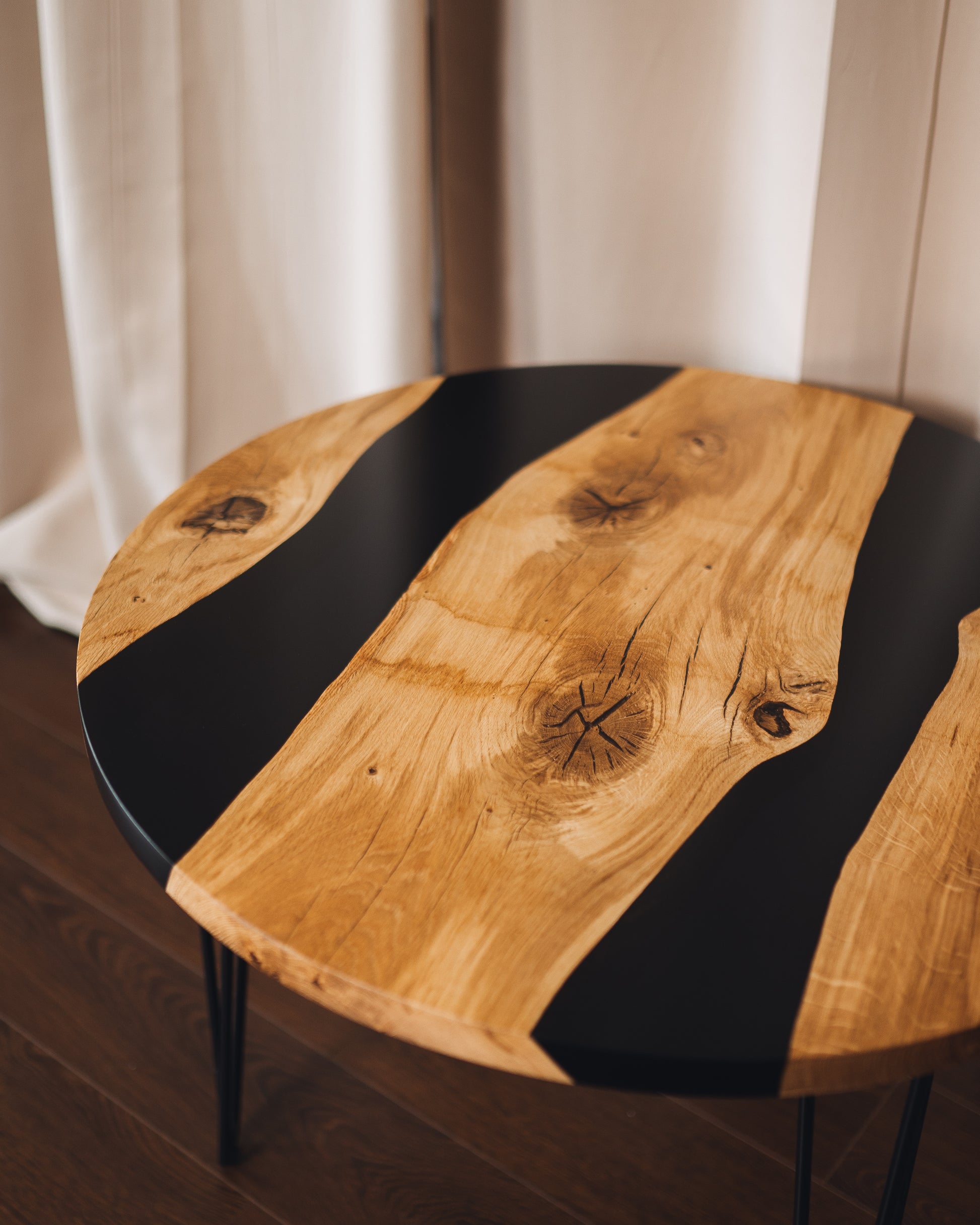 Top-down view of round oak epoxy table showing wood grain